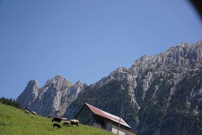 Panoramic view of mountain range against clear blue sky