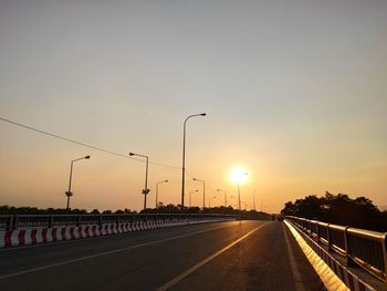 Street against sky during sunset