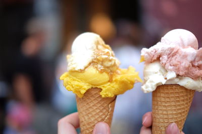 Close-up of person holding ice cream cones