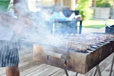 Man working on barbecue grill