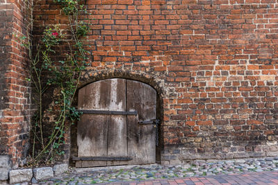 Open door of brick wall