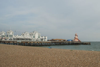 Scenic view of sea by buildings against sky