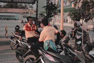 People riding motorcycle on street in city