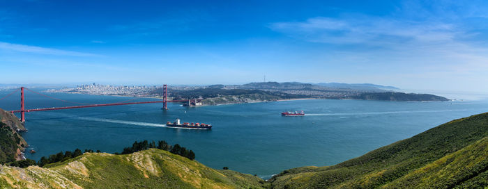 Golden gate bridge over bay against cloudy sky