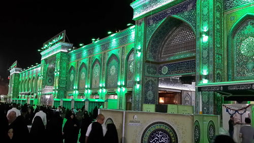 Group of people in illuminated building at night