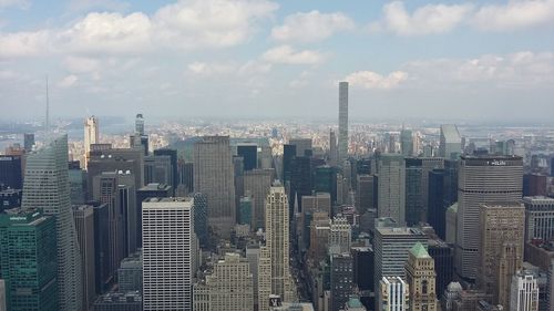 Aerial view of modern buildings in city against sky