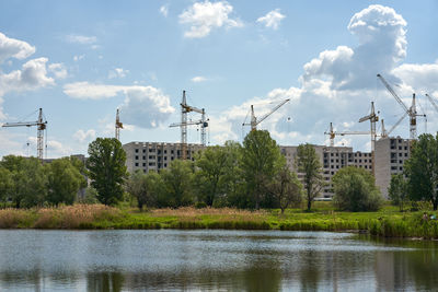 Scenic view of river by trees against sky