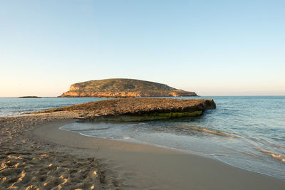 Scenic view of beach against clear sky