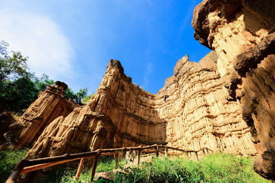 Low angle view of rock formation against sky