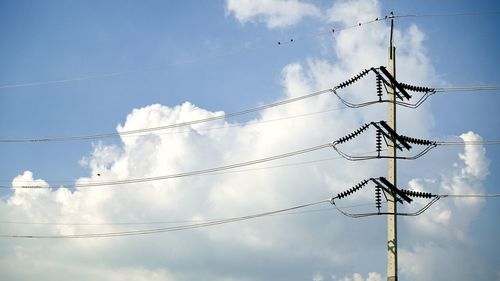 Low angle view of electricity pylon against sky