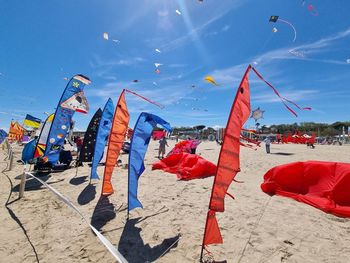 Low angle view of people on beach against sky