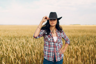 Rear view of woman standing on field