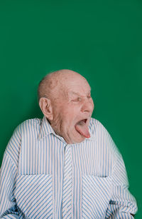 Portrait of man wearing mask against gray background