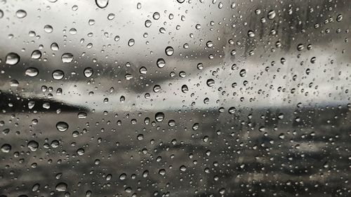 Full frame shot of raindrops on glass window