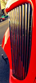 Close-up of red car on white background