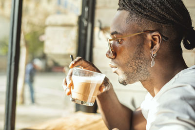 Portrait of young man drinking coffee