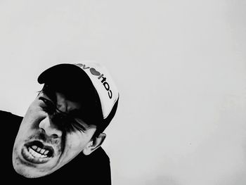 Portrait of young man against wall