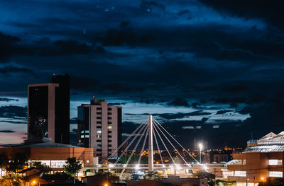 Illuminated cityscape against sky at night