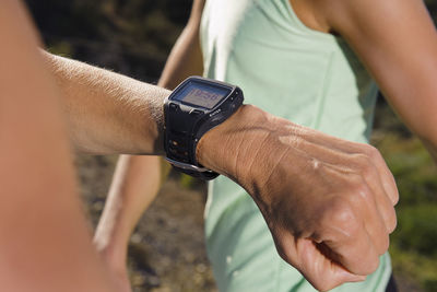 Man checking time and pulse during running, close-up