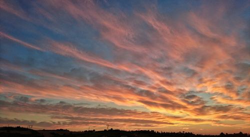 Low angle view of dramatic sky during sunset