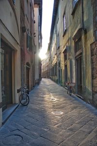 Narrow street amidst buildings in city