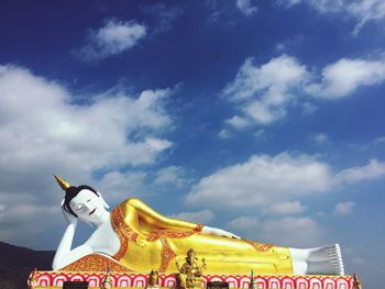 Low angle view of carousel statue against sky