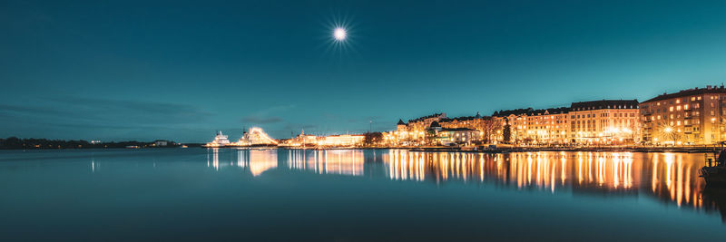 Scenic view of lake against sky at night