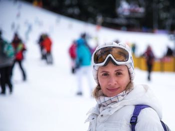 Portrait of smiling young woman in snow