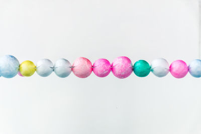 Close-up of multi colored candies against white background