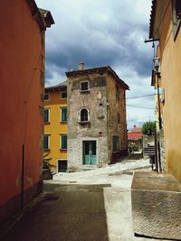 Street amidst buildings in town against sky