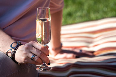 Midsection of woman holding champagne flute 