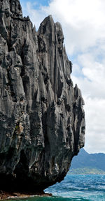 Rock formations in sea against sky