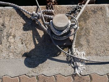 Close-up of rope tied up on chain