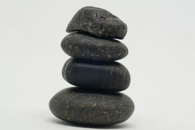 Close-up of stone stack against white background