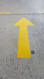 Yellow arrow symbol on road