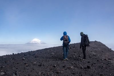 Male hikers hiking on mountain during winter