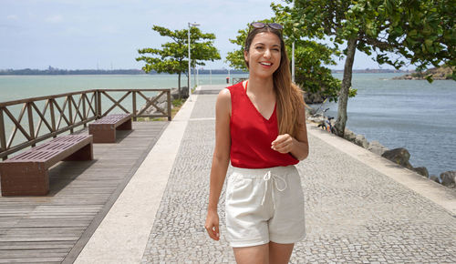 Portrait of brazilian woman walking on pier in vitoria, espirito santo, brazil