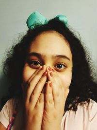 Close-up portrait of a girl covering face