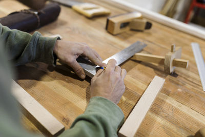 Low section of man working on wood