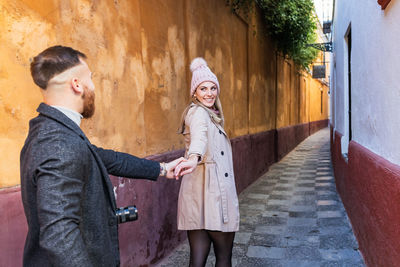 Young couple standing in alley