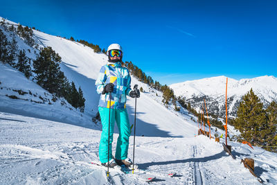 Portrait of a woman skier with ski on, looking at camera, pyrenees mountains, andorra