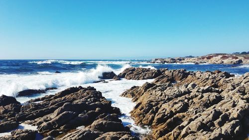 Scenic view of sea against clear blue sky