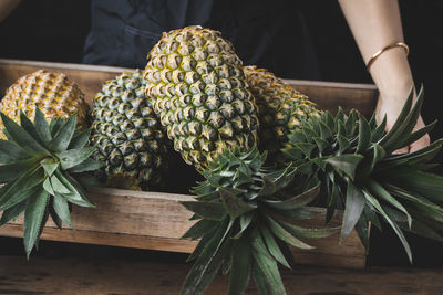 Close-up of person holding pineapple tray