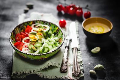 High angle view of salad with soup served on table