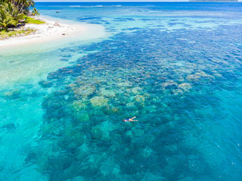 High angle view of people swimming in sea