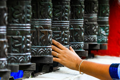 Close-up of person working in temple