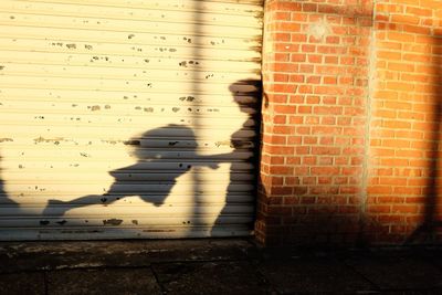 Shadow of built structure on brick wall