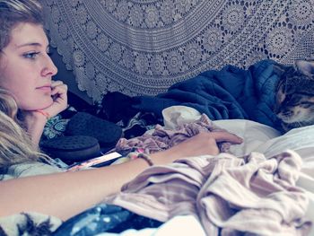 Young woman lying on bed