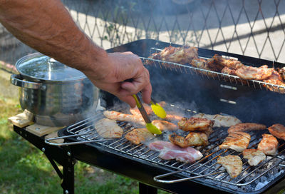 Man preparing food on barbecue grill