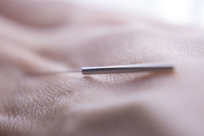 Cropped hand holding needle